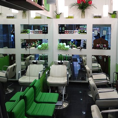 Inside Jonny's Place: white chairs, lime green seats and mirrored shelves